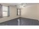 Empty bedroom with a ceiling fan and two large windows at 5104 W Fulton St, Phoenix, AZ 85043
