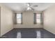 Empty bedroom with a ceiling fan and windows at 5104 W Fulton St, Phoenix, AZ 85043