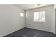 A bright bedroom with gray tile floors features two windows that provide natural light at 5104 W Fulton St, Phoenix, AZ 85043