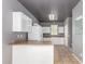Bright kitchen featuring white cabinets, appliances, and a breakfast bar at 5104 W Fulton St, Phoenix, AZ 85043