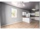 Open floor plan features breakfast bar, kitchen, and well-lit window at 5104 W Fulton St, Phoenix, AZ 85043