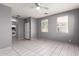 Well-lit living room features tile flooring and open layout to the kitchen at 5104 W Fulton St, Phoenix, AZ 85043