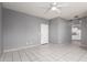 Spacious living room with sleek tile flooring and modern ceiling fan fixture at 5104 W Fulton St, Phoenix, AZ 85043