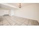 Spacious basement area with tiled floors, white walls, and steps that lead to the upper floor at 5166 N 83Rd St, Scottsdale, AZ 85250