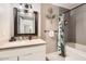 Bathroom featuring a decorative mirror, vanity, and shower with tropical accents at 5166 N 83Rd St, Scottsdale, AZ 85250