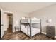 Comfortable bedroom features a bunk bed, wood floors, and neutral decor at 5166 N 83Rd St, Scottsdale, AZ 85250