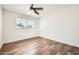 Bright bedroom with window and ceiling fan features stylish wood-look floors at 5166 N 83Rd St, Scottsdale, AZ 85250
