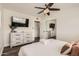 Bright bedroom with a dresser, mounted tv, ceiling fan, and closet at 5166 N 83Rd St, Scottsdale, AZ 85250