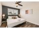 Cozy bedroom featuring a ceiling fan, window, and stylish accent wall at 5166 N 83Rd St, Scottsdale, AZ 85250