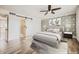 Bedroom featuring a sliding barn door to bathroom, patterned wallpaper, and light-colored furniture at 5166 N 83Rd St, Scottsdale, AZ 85250