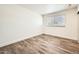 Bright bedroom with window features stylish wood-look floors and neutral walls at 5166 N 83Rd St, Scottsdale, AZ 85250