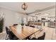 Open-concept dining area with a wooden table, modern chairs, and a view of the kitchen at 5166 N 83Rd St, Scottsdale, AZ 85250
