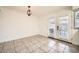 Bright dining area with tiled floor, white walls, and French doors leading to the backyard at 5166 N 83Rd St, Scottsdale, AZ 85250