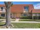 Inviting townhome featuring a unique red-tiled roof, manicured lawn, and a charming front entrance at 5166 N 83Rd St, Scottsdale, AZ 85250