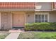 Charming townhouse with a unique red-tiled roof, welcoming front entrance, and well-manicured lawn at 5166 N 83Rd St, Scottsdale, AZ 85250