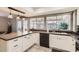 Bright kitchen boasts white cabinets, modern appliances, and a large window offering ample natural light at 5166 N 83Rd St, Scottsdale, AZ 85250