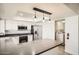 Spacious kitchen with gray countertops, stainless steel appliances, and three pendant lights at 5166 N 83Rd St, Scottsdale, AZ 85250