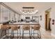 Spacious kitchen features white cabinets, updated stainless appliances, and a breakfast bar with seating at 5166 N 83Rd St, Scottsdale, AZ 85250