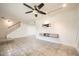 Spacious living room featuring neutral tile floors, a ceiling fan, and modern wall decor at 5166 N 83Rd St, Scottsdale, AZ 85250