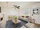 Bright living room with a ceiling fan, modern furnishings, large windows, and an accent wall at 5166 N 83Rd St, Scottsdale, AZ 85250