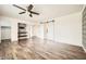 Spacious main bedroom offers a stylish barn door to bath, wood floors, and modern finishes at 5166 N 83Rd St, Scottsdale, AZ 85250