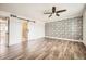 Main bedroom features stylish wood floors, wallpaper accent wall, and a barn door leading to bath at 5166 N 83Rd St, Scottsdale, AZ 85250