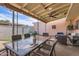Outdoor patio space with a glass dining table and comfortable seating area at 5166 N 83Rd St, Scottsdale, AZ 85250
