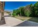 View of backyard with patio and lush landscaping with mature plants and trees at 560 E San Pedro Ave, Gilbert, AZ 85234