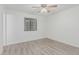 Bedroom featuring light gray wood-look flooring and a ceiling fan at 560 E San Pedro Ave, Gilbert, AZ 85234