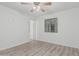 Bright bedroom with light gray wood-look flooring and a ceiling fan at 560 E San Pedro Ave, Gilbert, AZ 85234