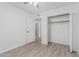 Bedroom with wood-look flooring, closet, and doorway to bathroom at 560 E San Pedro Ave, Gilbert, AZ 85234