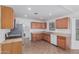 Traditional kitchen with wood cabinets, stainless steel refrigerator, and linoleum flooring at 560 E San Pedro Ave, Gilbert, AZ 85234