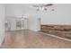 Spacious living room with decorative wood paneling, ceiling fans and patio access at 560 E San Pedro Ave, Gilbert, AZ 85234