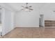 Bright living room featuring a ceiling fan, tiled flooring, and open access to other rooms at 560 E San Pedro Ave, Gilbert, AZ 85234