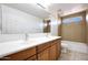 Bathroom features double sink vanity, full mirror, and tub shower with a small window at 5726 W Park View Ln, Glendale, AZ 85310