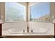 Bright bathroom featuring a tub with views at 5726 W Park View Ln, Glendale, AZ 85310
