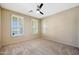 Comfortable bedroom with neutral carpet, plantation shutters, and plenty of natural light at 5726 W Park View Ln, Glendale, AZ 85310