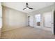 Bedroom with carpet, ceiling fan, and doors leading to the bathroom and closet at 5726 W Park View Ln, Glendale, AZ 85310