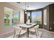 Charming dining room with modern lighting, large windows, neutral tones, and stylish table setting at 5726 W Park View Ln, Glendale, AZ 85310