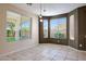 Inviting dining area with large windows providing natural light and a view of the outdoor greenery at 5726 W Park View Ln, Glendale, AZ 85310
