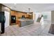 Expansive kitchen showcasing a center island with bar seating, tile flooring, and access to dining area at 5726 W Park View Ln, Glendale, AZ 85310