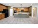 Bright kitchen featuring a large island with a sink, ample counter space, and wood-look cabinetry at 5726 W Park View Ln, Glendale, AZ 85310