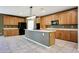 Well-lit kitchen with abundant cabinetry, sleek appliances, an island with seating, and tile floors at 5726 W Park View Ln, Glendale, AZ 85310