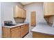Practical laundry room with cabinetry, a sink, and counter space for chores and cleaning at 5726 W Park View Ln, Glendale, AZ 85310