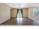 Spacious living room features hard floors, ceiling fan, and access to the backyard through french doors at 5726 W Park View Ln, Glendale, AZ 85310