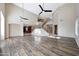 Bright living room boasts high ceilings, wood floors, and a grand staircase leading to the upper level at 5726 W Park View Ln, Glendale, AZ 85310