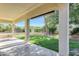 Covered patio framing a landscaped yard, pool, and clear blue skies at 5726 W Park View Ln, Glendale, AZ 85310