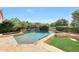 Luxury pool with a stone surround, integrated spa, and verdant landscaping at 5726 W Park View Ln, Glendale, AZ 85310