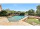 Luxury pool with a stone surround, integrated spa, and verdant landscaping at 5726 W Park View Ln, Glendale, AZ 85310