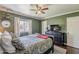 Bedroom showcases a ceiling fan, a window, and comfortable furnishings at 601 E Palo Verde Dr # 27, Phoenix, AZ 85012